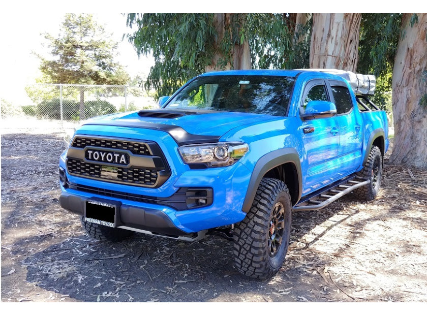 Blue Toyota Tacoma with Heavy Metal Off-Road Bed Bars over the truck bed