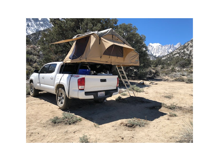 White Toyota Tundra with rooftop tent at a desert campsite