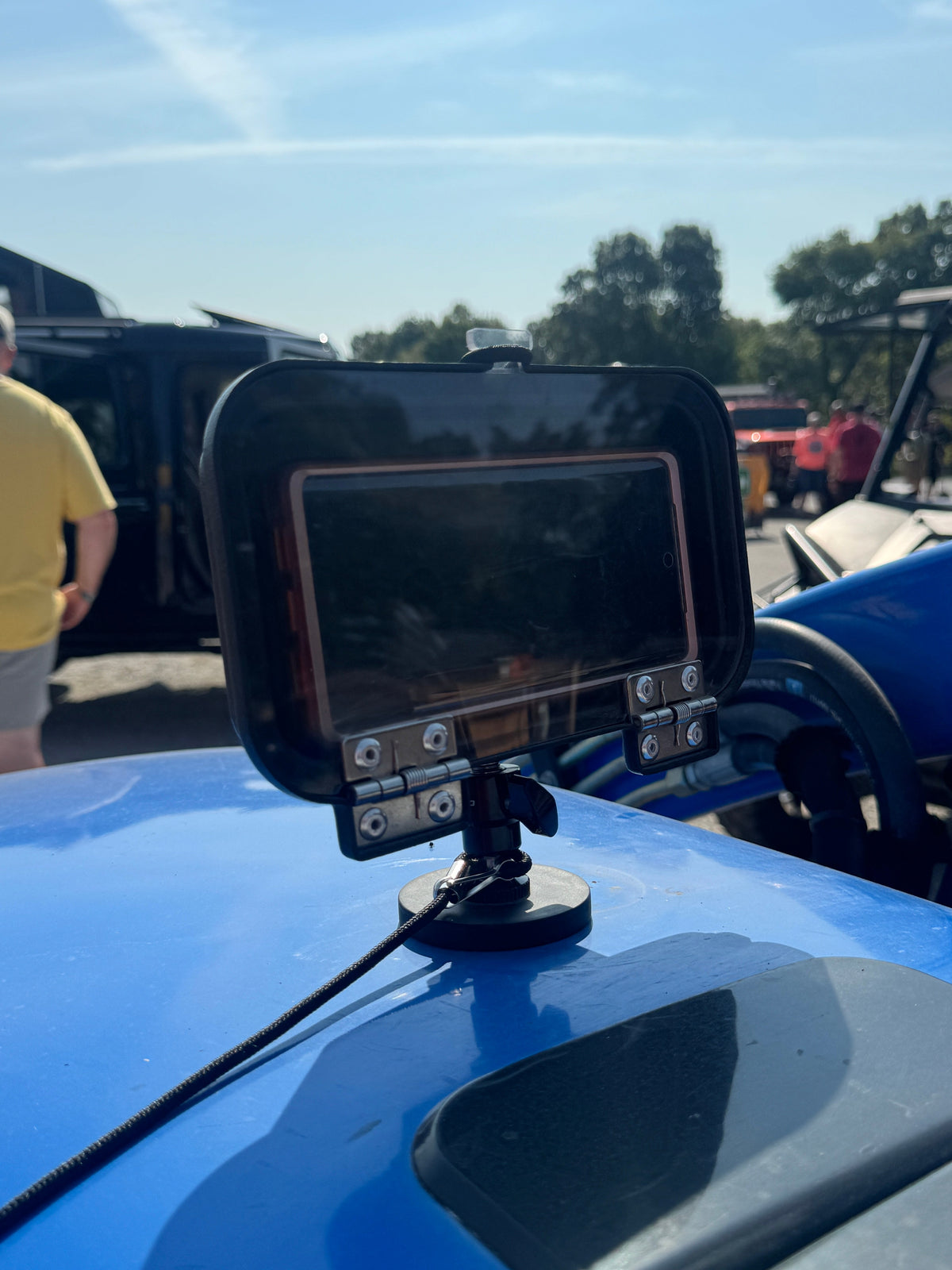 Adjustable CallHaul magnetic phone mount attached to a tractor hood