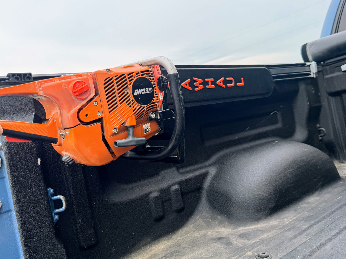 SawHaul Snap-Lok chainsaw scabbard mounted on a Toyota truck bed rail