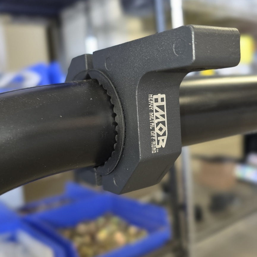 HMOR bolt-on round tube accessory mount installed on a curved Bed Bar tube